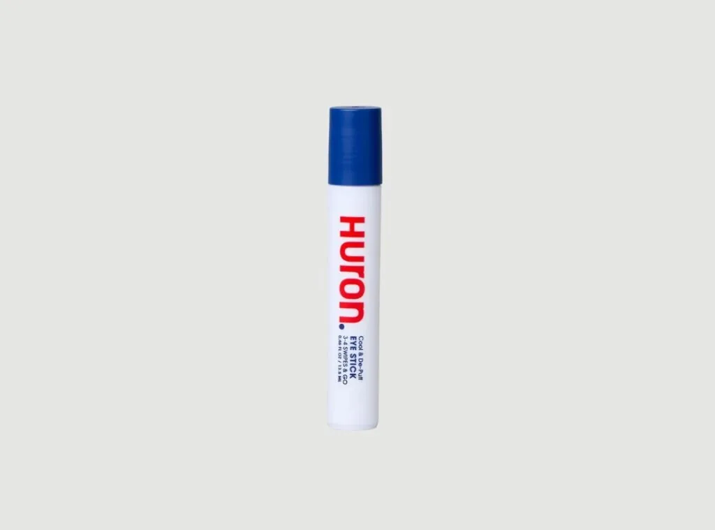 Huron Eye Stick tube with cooling metal rollerball, a vegan men's caffeine de-puffing under-eye serum with snow mushroom and soothing botanicals